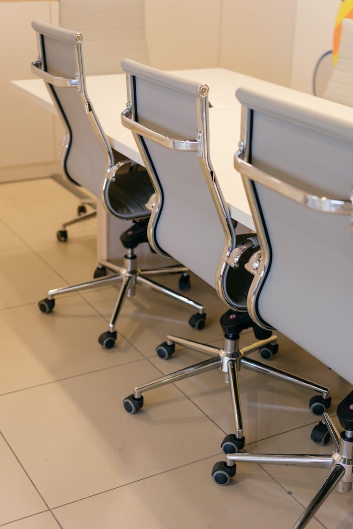 Contemporary office space featuring stylish chairs and a sleek white table, ideal for corporate settings.